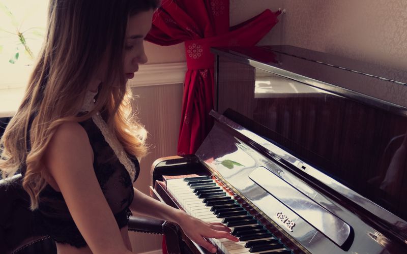 Mila Azul speelt piano in lingerie en naakt